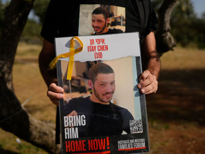 Title: Israel Memorial Day Image ID: 24130622289509 Article: Ruby Chen holds a poster of h