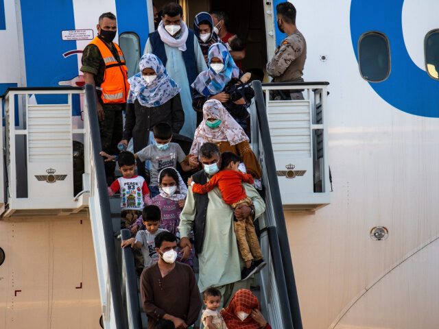 Afghan Evacuees Afghan people disembarking from the last plane with evacuees from Afghanistan in the Milit