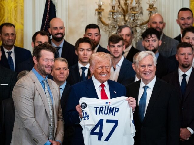 US President Donald Trump, center, holds a baseball jersey alongside Clayton Kershaw, pitc