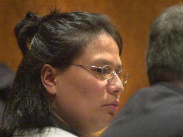 Staff Photo by Doug Jones, Monday, November 3, 2003: Angela Humphrey sits with her attorne