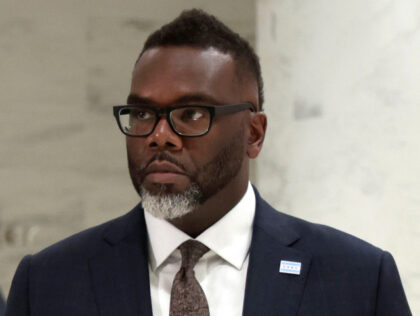 Illinois Gov. J.B. Pritzker, left,(not seen) and Chicago Mayor Brandon Johnson arrive for