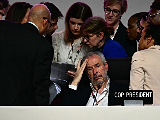 COP30 President Andre Correa do Lago (C) gestures next to his advisers after the plenary s