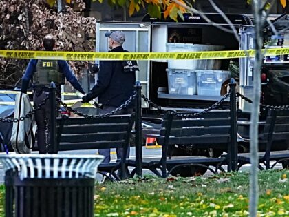 Agents with the Federal Bureau of Investigation (FBI) near the scene of a shooting in Wash
