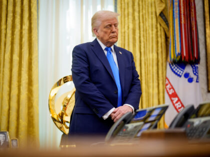 U.S. President Donald Trump stands for a prayer during a swearing-in ceremony in the Oval
