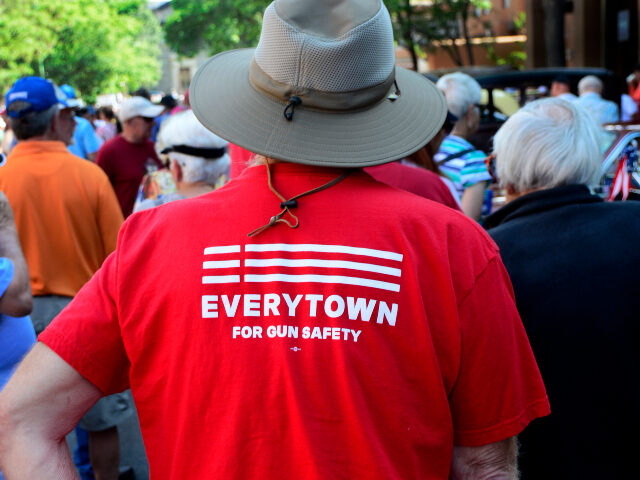 A man wears a 'Moms Demand Action for Gun Sense in America' T-shirt at a Fourth