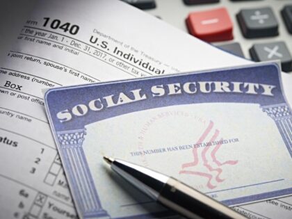 Social Security Card on calculator with pen