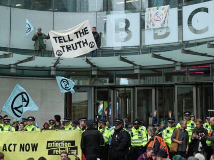 Protesters and police in front of the entrance to the BBC New Broadcasting House in London