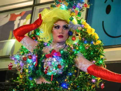 A drag queen dressed as a Christmas tree entertains the public in downtown Bangkok on Dece