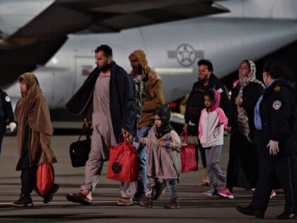 KOSOVO-AFGHANISTAN-CONFLICT-EVACUATION Afghan refugees, fleeing the Afghan capital Kabul, exit an US air force plane upon their a
