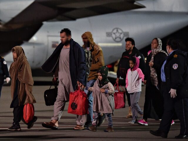 KOSOVO-AFGHANISTAN-CONFLICT-EVACUATION Afghan refugees, fleeing the Afghan capital Kabul, exit an US air force plane upon their a