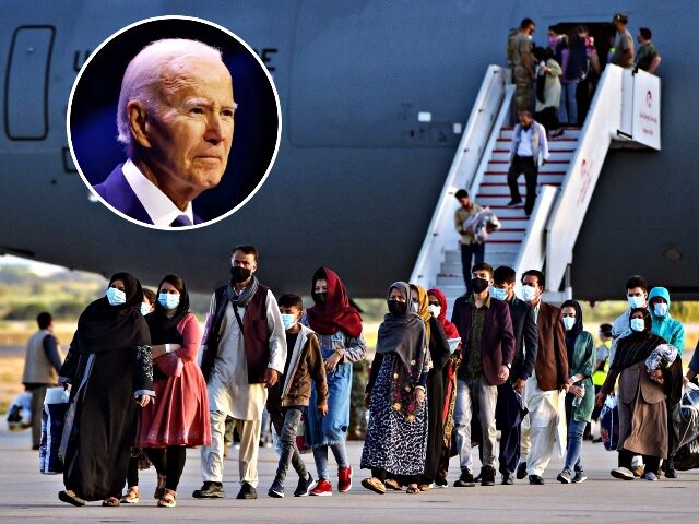 Refugees disembark from a US air force aircraft after an evacuation flight from Kabul at t