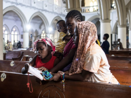 Catholic worshippers recite lines during the stations of the cross prayers at the Holy Cro