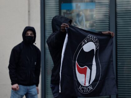 An Anti Fascist Action flag is displayed by a protester during a demonstration on a nation