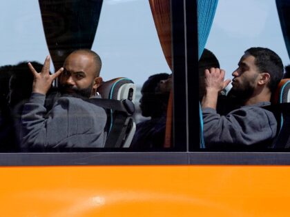 People believed to be migrants leaving by bus from the Border Force compound in Dover, Ken