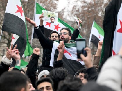 Members of the Syrian community wave Syrian flags on December 8, 2024 in Berlin, Germany,