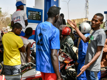 People queue for petrol at a fuel station in the outskirts of Niamey, on March 9, 2025. Si