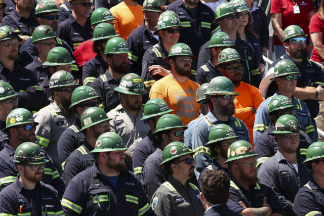 HUGER, SOUTH CAROLINA - MAY 1: Steel workers listen as U.S. Vice President JD Vance speaks