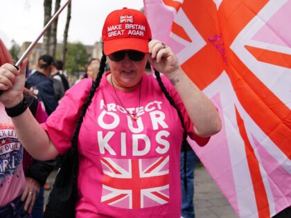 People take part in a Save Our Future & Our Kids Futures protest outside the Cladhan Hotel