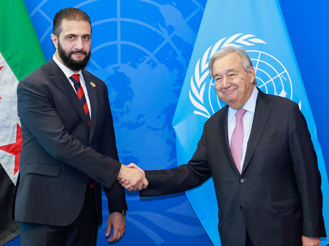 Syrian President Ahmed al-Sharaa (L) shake hands with UN Secretary-General Antonio Guterre