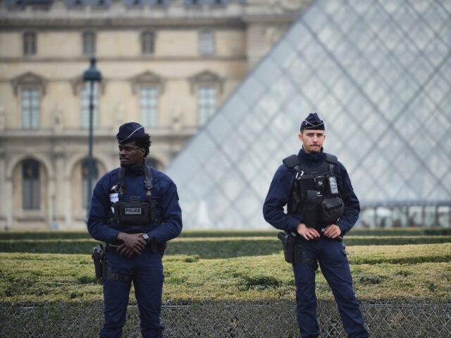 PARIS, FRANCE - OCTOBER 19: Police stand guard outside the Louvre museum at Louvre on Octo