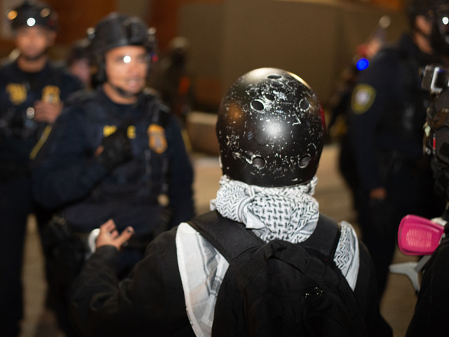 PORTLAND, OREGON, UNITED STATES - OCTOBER 22: People gather outside the Federal Immigratio