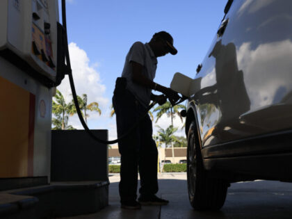 MIAMI, FLORIDA - OCTOBER 24: A customer pumps gas into their vehicle on October 24, 2025 i
