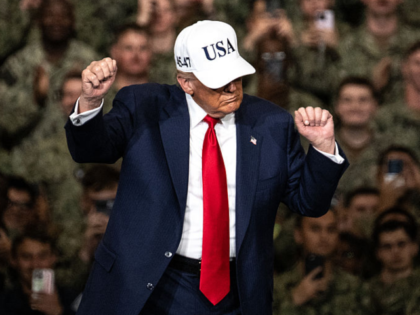 US President Donald Trump dances as he leaves after delivering a speech in front of US Nav