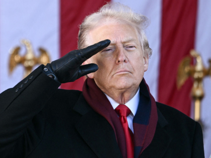 US President Donald Trump salutes at the conclusion of a Veterans Day ceremony at Arlingto