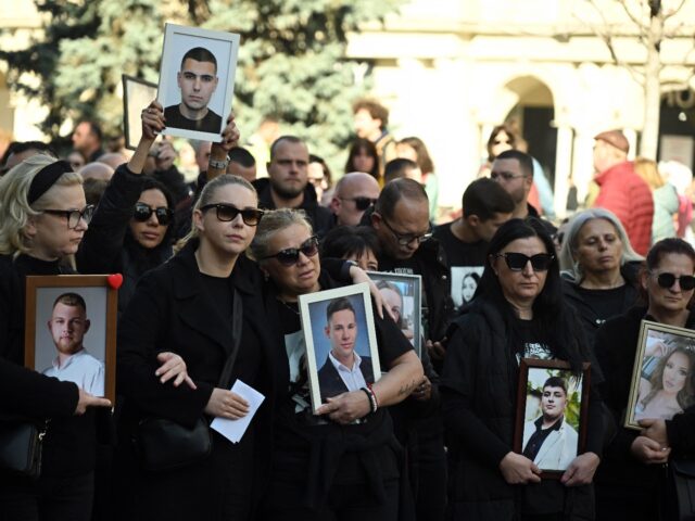 Relatives of the victims of a deadly nightclub fire on March 16, 2025 hold photographs of