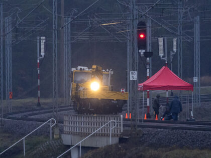 Technical workers are seen at the railways damaged in an explosion on the rail line in Mik