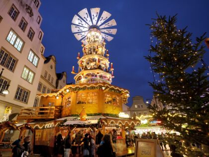 24 November 2025, Mecklenburg-Western Pomerania, Rostock: Christmas stalls and a giant Chr