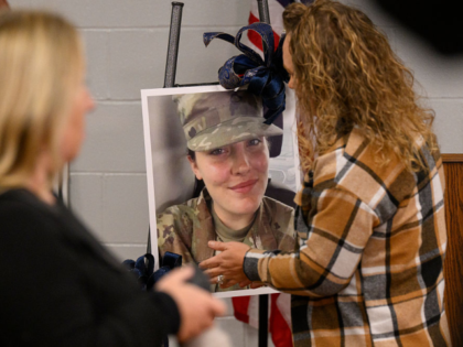 WEBSTER SPRINGS, WEST VIRGINIA - NOVEMBER 28: Community members prepare a portrait of West