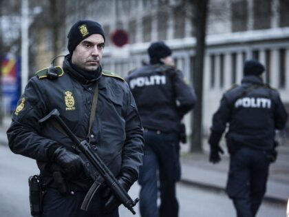 TOPSHOT - A police officer guards the street around the Noerrebro train station in Copenha