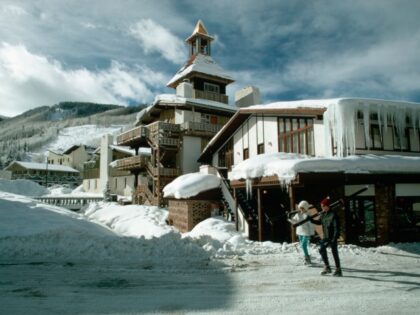 A couple carries their skis through Vail Village. Colorado. (Photo by Dean Conger/Corbis v