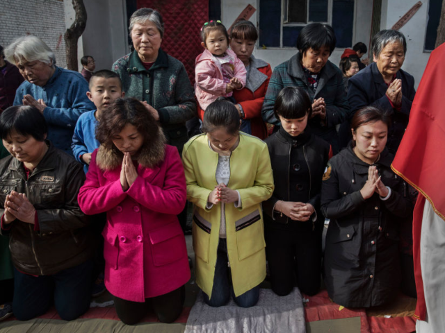 SHIJIAZHUANG, CHINA - APRIL 09: (CHINA OUT) A Chinese Catholic worshippers wait to take co