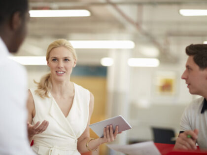 Creative business people using digital tablet in meeting