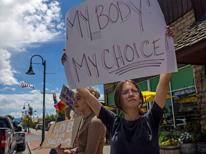 A group of teenagers protests the Supreme Court's decision in the Dobbs v Jackson Women's