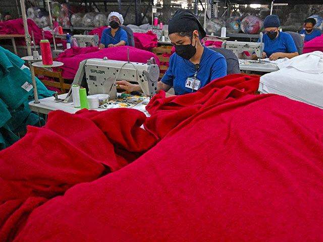 Employees work at a textile factory, in Bogota on January 14, 2025. (Photo by Raul ARBOLED