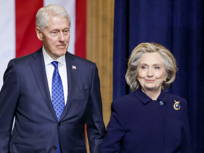 Former US President Bill Clinton, center, and Hillary Clinton, former US secretary of stat