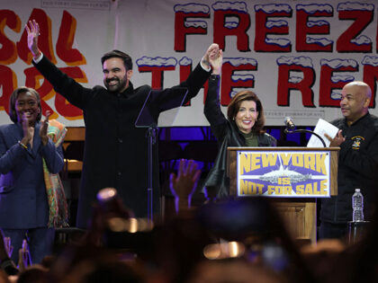 New York City mayoral candidate Zohran Mamdani (2L) holds hands with New York Governor Kat