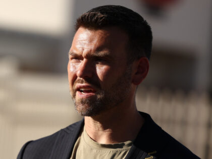 Political activist Jack Posobiec visits the makeshift memorial for right-wing activist and