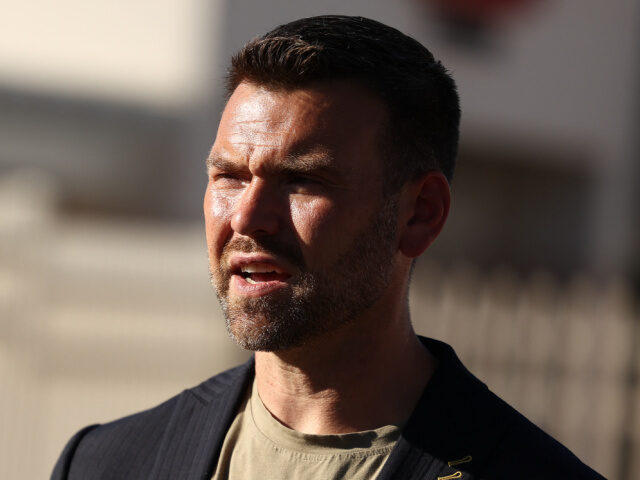 Political activist Jack Posobiec visits the makeshift memorial for right-wing activist and