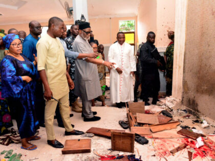 Ondo State governor Rotimi Akeredolu (3rd L) points to blood the stained floor after an at