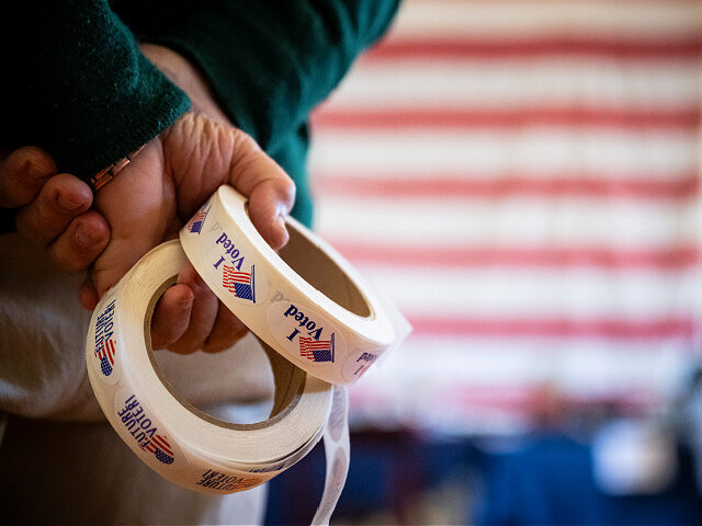 Nov4-2025-i-voted-stickers-election-day-file-getty An election worker holds "I Voted" stickers at a polling station at the Old Stone School i