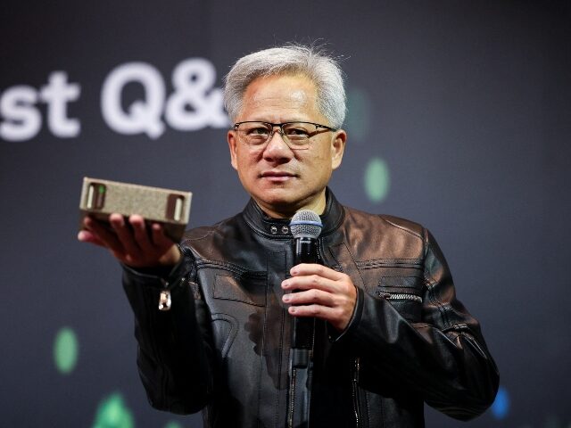 Nvidia's Jensen Huang holding up a chip