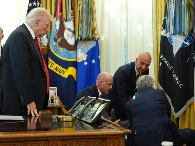 Commerce Secretary Howard Lutnick, from left, President Donald Trump, David Moore, preside