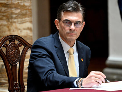 Bolivia's President Rodrigo Paz signs a document during the inauguration ceremony of