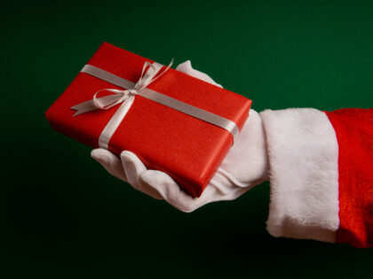 Secret Santa with gift in hand