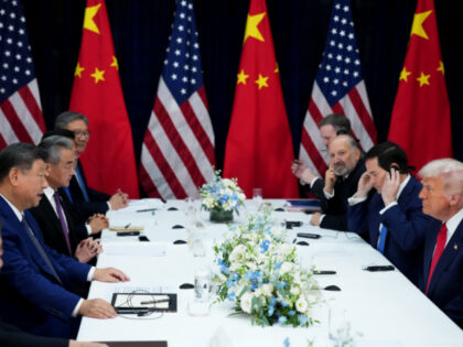 U.S. President Donald Trump (R) speaks with Chinese President Xi Jinping during a bilatera