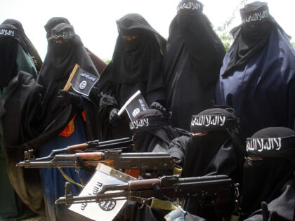 Somali women carry weapons during a demonstration organized by the islamist Al-Shabaab gro